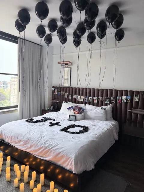 Black ceiling balloons with ribbon tails for a room surprise