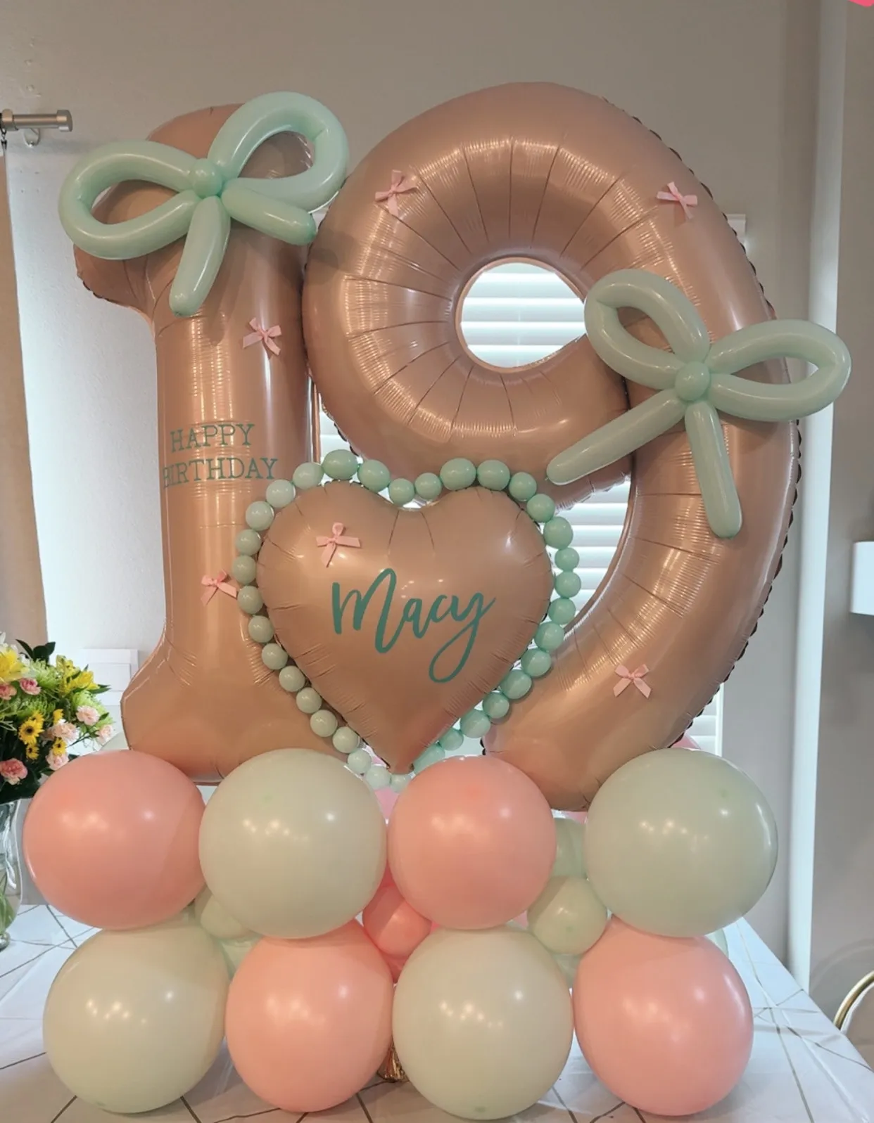 Jumbo number stack with a personalized heart, twisted bows and a pastel base