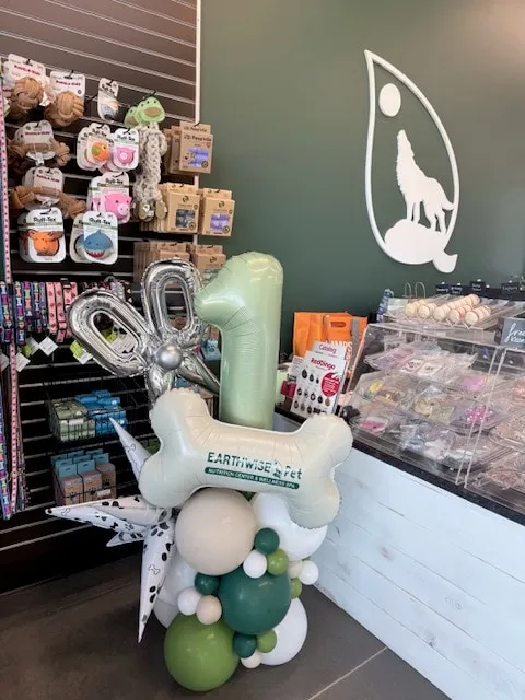 Custom column with a printed bone, foil number and scissors for a pet store celebration
