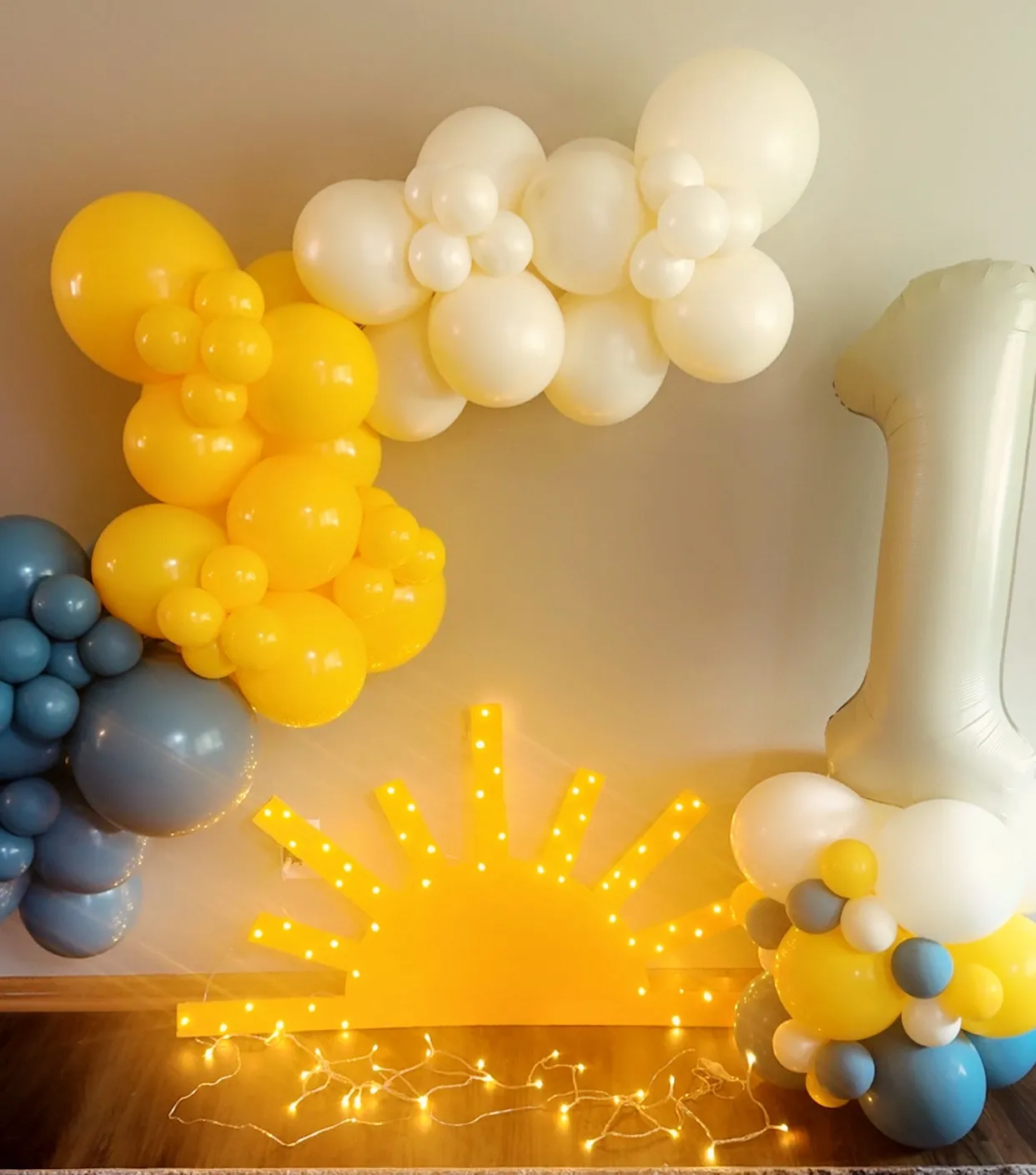 Sunshine first birthday garland in yellow, cream and dusty blue, with a number column
